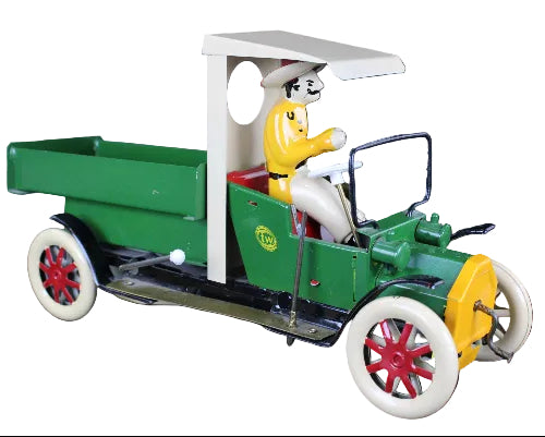 Model of a vintage green truck with a driver figure on a dark background