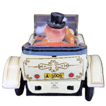 Toy car with a character in a top hat on a dark background