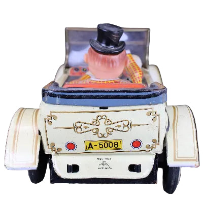 Toy car with a character in a top hat on a dark background