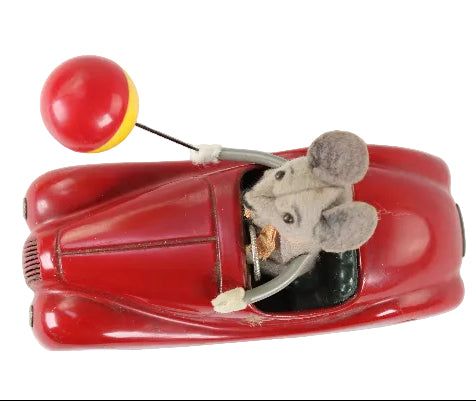 Toy car with a mouse figure inside on a white background