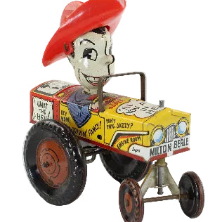 Toy tractor with Milton Berle character in a red hat on a white background