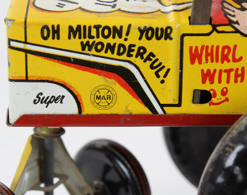 Marx toy tin with text 'Oh Milton! Your wonderful!' and 'Super' on a white background