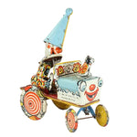 Colorful vintage toy car with a clown face on a white background