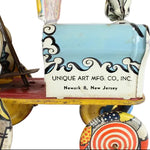 Vintage toy with 'Unique Art Mfg. Co., Inc.' branding on a white background