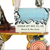 Vintage toy with 'Unique Art Mfg. Co., Inc.' branding on a white background