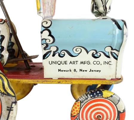 Vintage toy with 'Unique Art Mfg. Co., Inc.' branding on a white background