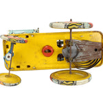 Vintage toy car with a yellow body and metal components on a white background