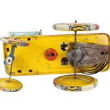 Vintage toy car with a yellow body and metal components on a white background