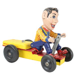 Howdy Doody toy figure driving a yellow toy car on a white background