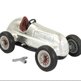Model of a vintage Mercedes Benz race car with a silver body and black wheels on a white background