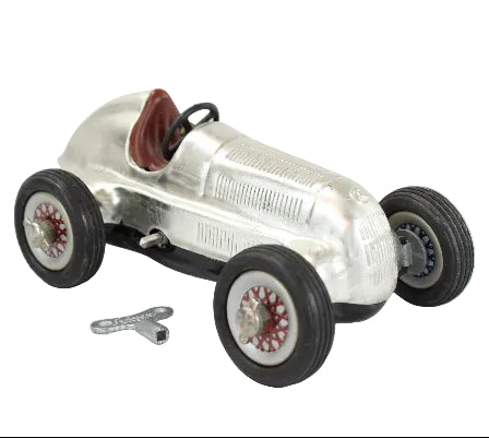 Model of a vintage Mercedes Benz race car with a silver body and black wheels on a white background