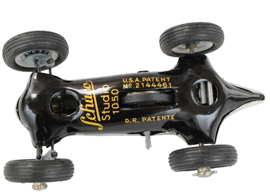Vintage toy car with 'Schuco' branding and patent details on a white background