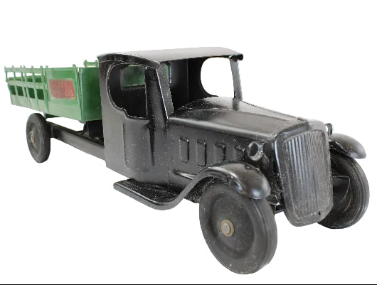 Vintage toy truck with a green bed on a white background