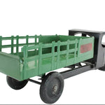 Model truck with green bed and black body on a white background
