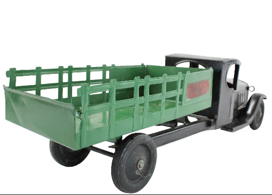 Model truck with green bed and black body on a white background