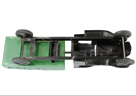 Model car chassis with green base and black components on a white background