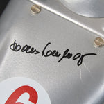 Close-up of Hans Herrmann autograph on metallic surface with signature and logo