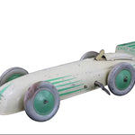 Vintage toy race car with green accents on a dark background