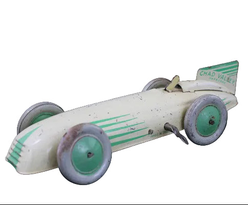 Vintage toy race car with green accents on a dark background