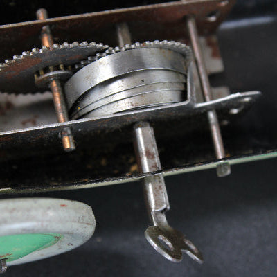 Close-up of mechanical components with gears and metal parts on a dark background