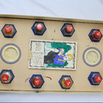 Vintage game board with hexagonal tiles and central illustration on a cardboard box.