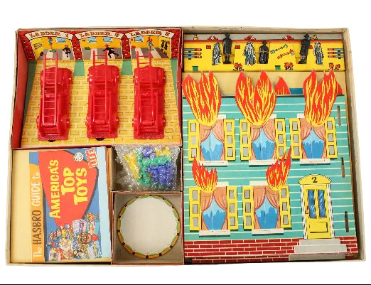 Vintage toy set with fire engine, building model, and accessories on a white background