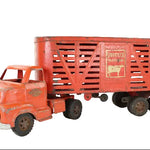 Vintage toy truck with a red trailer on a white background