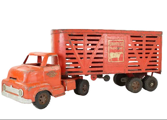 Vintage toy truck with a red trailer on a white background
