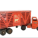 Red toy truck with a livestock transport trailer on a white background
