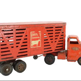 Red toy truck with a livestock transport trailer on a white background