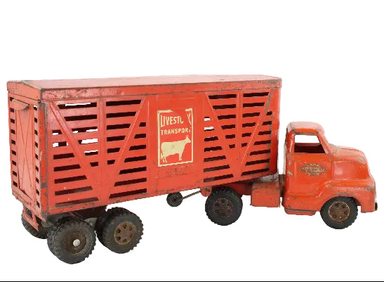Red toy truck with a livestock transport trailer on a white background
