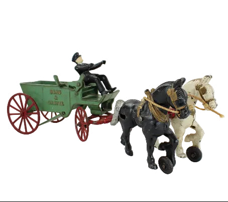 Toy figure of a man in a green cart pulled by two horses on a white background