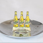 Three Senate Ale bottles on a metallic tray with a white background