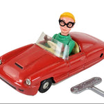 Toy car with a figure inside and a key on a white background