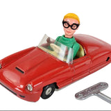 Toy car with a figure inside and a key on a white background