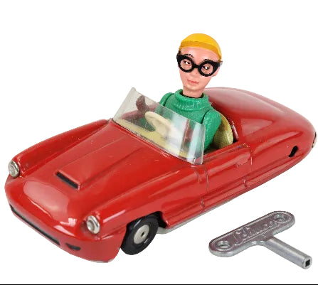 Toy car with a figure inside and a key on a white background