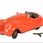 Red toy car with a key on a light gray background