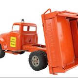 Model of a red dump truck with an open bed on a white background