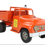 Model of an orange dump truck with a yellow sign on a white background