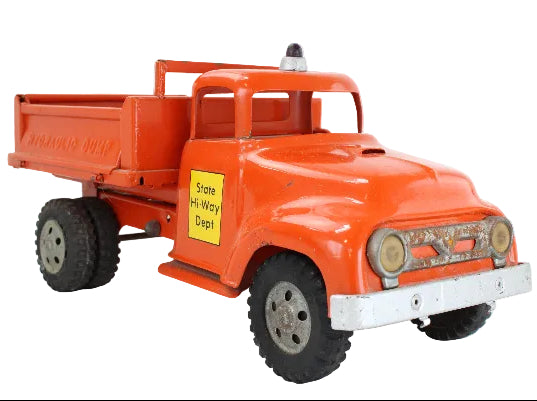 Model of an orange dump truck with a yellow sign on a white background