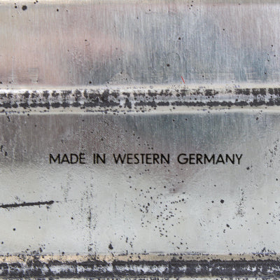 Text 'MADE IN WESTERN GERMANY' on a textured surface