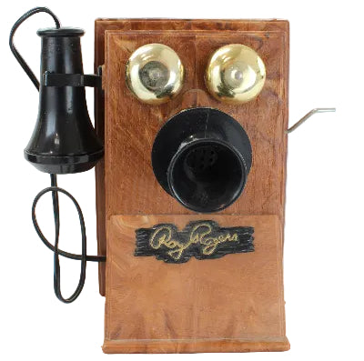 Vintage wooden telephone with black and gold components on a white background