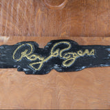 Wooden box with 'Roy Rogers' logo in gold on a wooden background