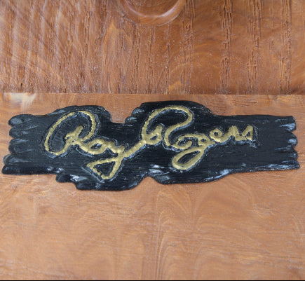 Wooden box with 'Roy Rogers' logo in gold on a wooden background