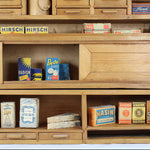 Wooden shelf with vintage toy boxes and packaging on a white background