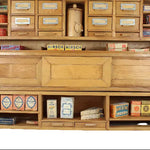 Wooden cabinet with vintage-style product packaging on a white background