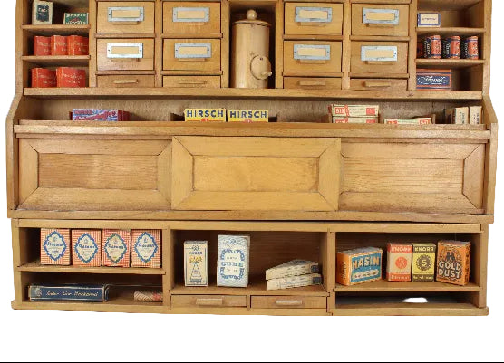 Wooden cabinet with vintage-style product packaging on a white background