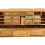 Wooden storage unit with multiple drawers and shelves on a white background
