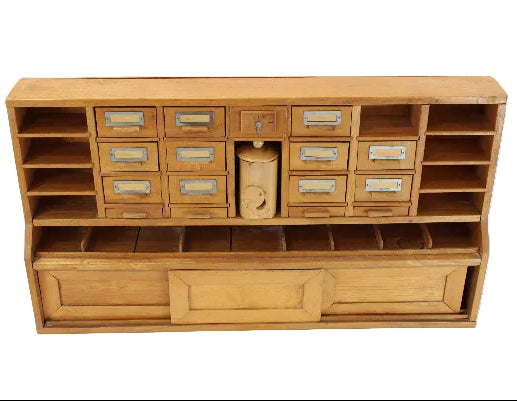 Wooden storage unit with multiple drawers and shelves on a white background