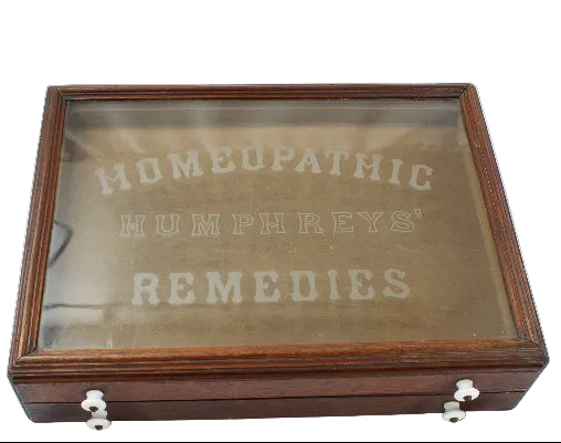 Wooden box with glass top displaying 'Homeopathic Humphreys' Remedies' on a white background